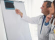 Concentrated medical colleagues examining x-ray together